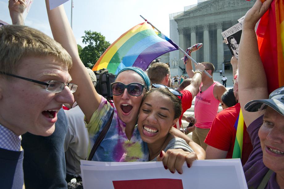 Gay rights activists reacts outside the US Supreme Court building in Washington DC on June 26, 2013, after the court ruling on California's Proposition 8, the controversial ballot initiative that defines marriage as between a man and a woman. 