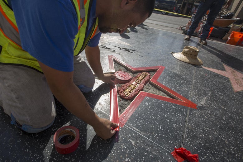 A worker repairs Donald Trump's star on the Walk of Fame.