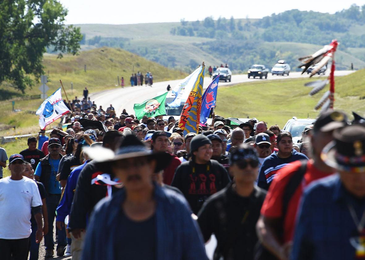 Protestors march to a construction site for the Dakota Access Pipeline to express their opposition to the pipeline, at an encampment where hundreds of people have gathered to join the Standing Rock Sioux Tribe's to protest against the construction of the new oil pipeline, near Cannon Ball, North Dakota, on September 3, 2016.