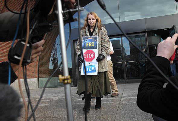 Elena Teyer walks to podium to address the media.