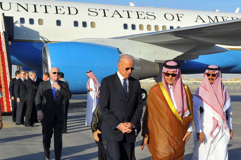 Biden speaks with two Saudi officials on the tarmac while walking away form Air Force II.