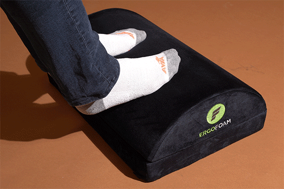 Feet testing the ErgoFoam footrest. 