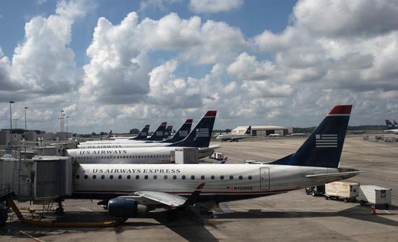 U.S. Airways planes lined up at a passenger terminal at the Charlotte Douglas International Airport in Charlotte, N.C., July 15, 2012.