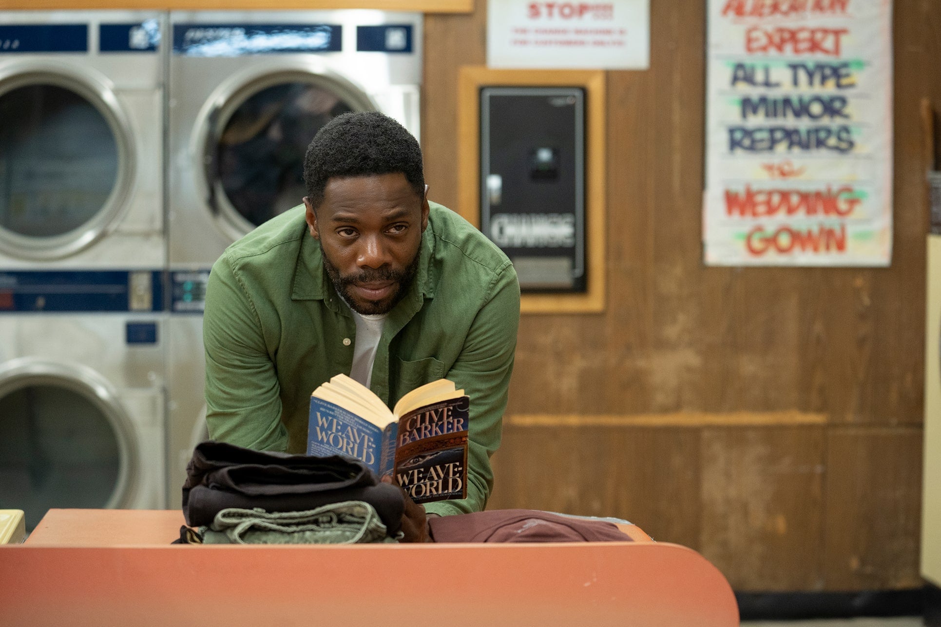 In a laundromat, Colman Domingo reads Clive Barker's Weave World.