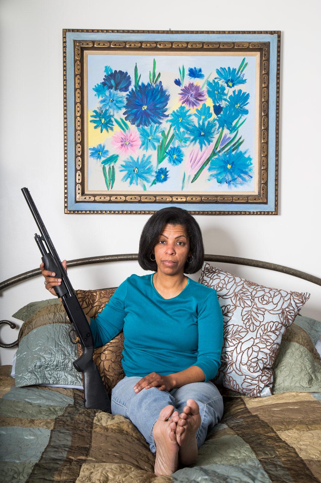 Millicent Hunter at her home on Feb. 12, 2013, in Fairfax, Va. Hunter keeps the pump-action shotgun under her bed. 
