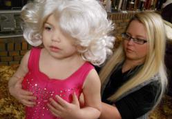 Madisyn “Maddy” Verst, left, dresses up for the TLC show "Toddlers and Tiaras".