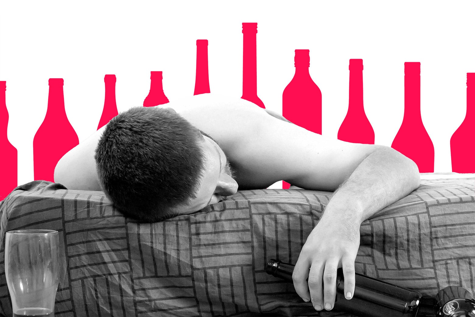 Man passed out drunk in bed with bottles lined up behind him.