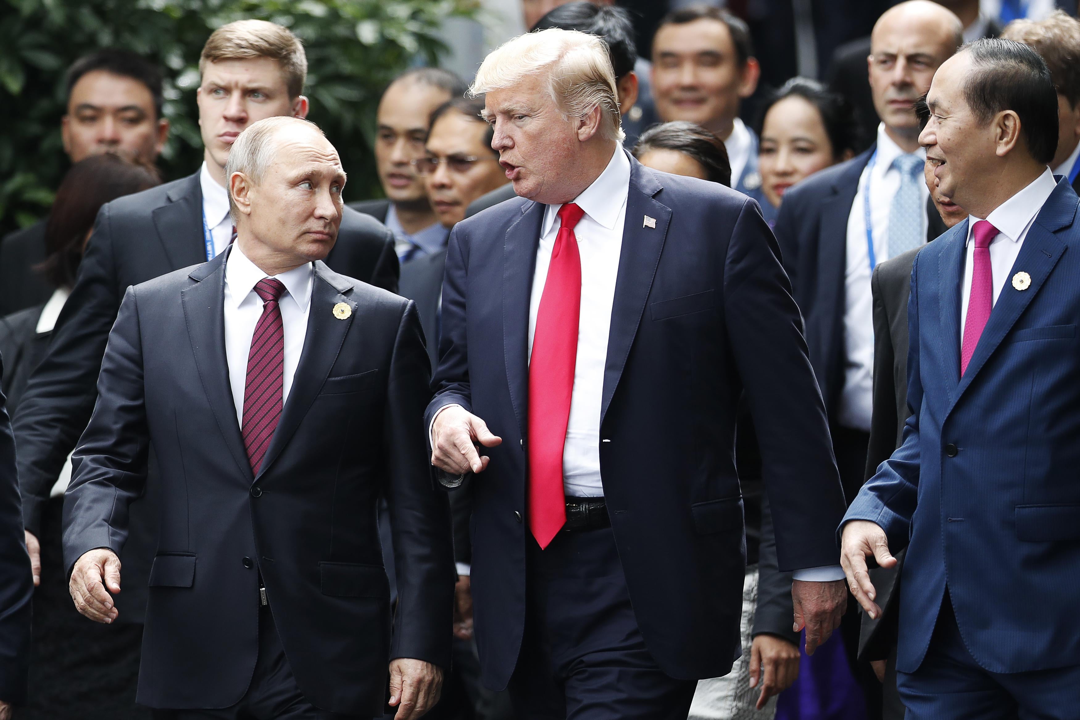 US President Donald Trump (C) and Russia's President Vladimir Putin talk as they make their way to take the 'family photo' during the Asia-Pacific Economic Cooperation (APEC) leaders' summit in the central Vietnamese city of Danang on November 11, 2017.
World leaders and senior business figures are gathering in the Vietnamese city of Danang this week for the annual 21-member APEC summit. / AFP PHOTO / POOL / JORGE SILVA        (Photo credit should read JORGE SILVA/AFP/Getty Images)