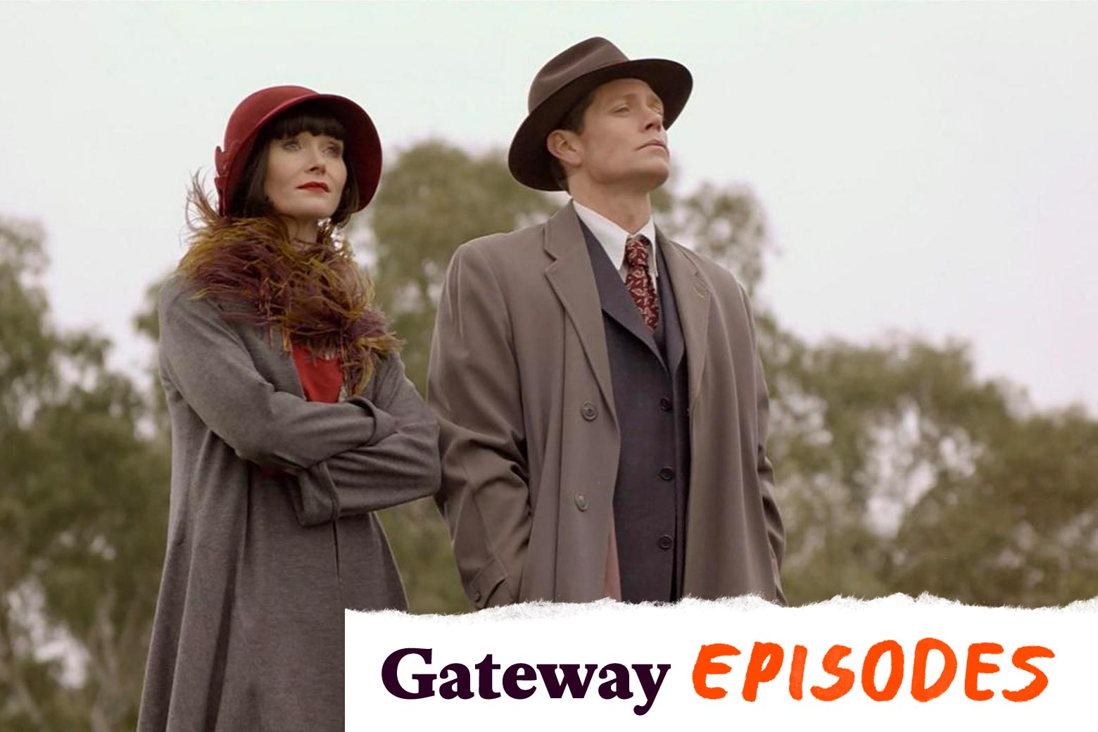 Essie Davis wears a red cloche hat and a fuzzy scarf, her hair cut in a blunt black bob. She stands next to Nathan Page, in a fedora and trench coat.