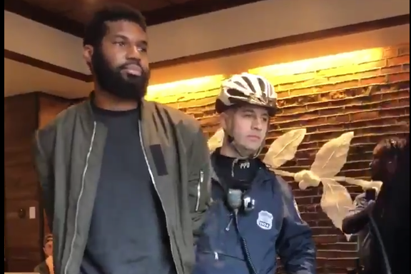 A screenshot from the video posted on Twitter shows an officer arresting one of two men in a Philadelphia Starbucks on April 12, 2018.