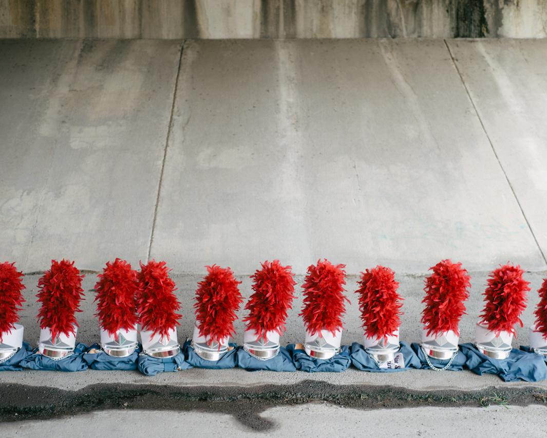 Blue Stars Uniforms. Uniforms are lined up beneath an overpass during warmups for the DCI Southwestern Championship, Blue Stars Drum & Bugle Corps, The Alamodome, San Antonio, Texas
