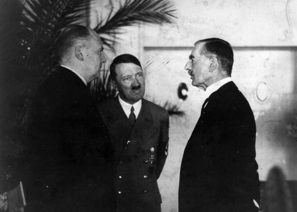 Hitler's interpreter Paul Schmidt conveying the Fuhrer's reply to a question from Neville Chamberlain during their meeting at the Hotel Dreesen at Godesberg.,96d/26/inns/4433/15