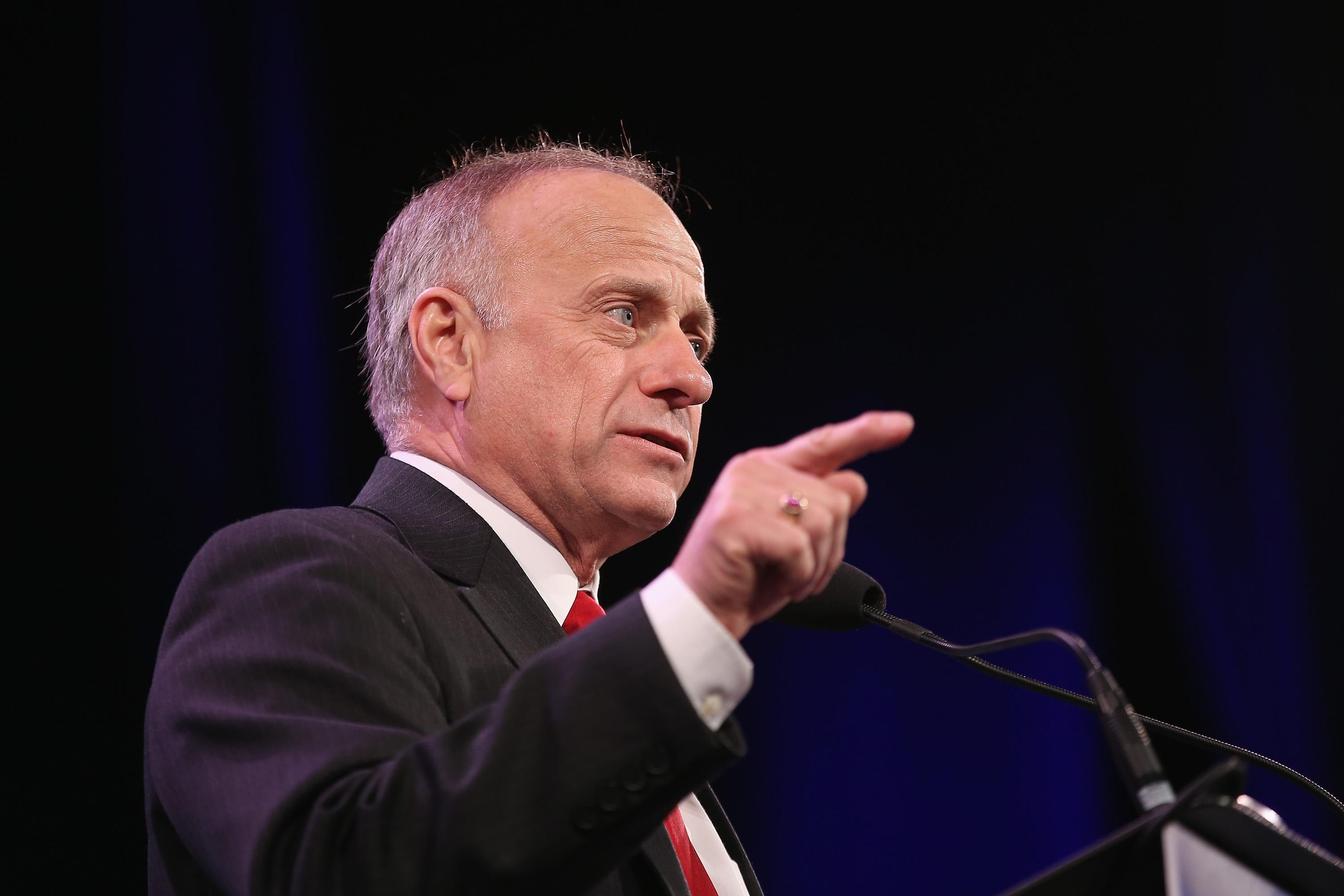 Steve King at a podium onstage, pointing.