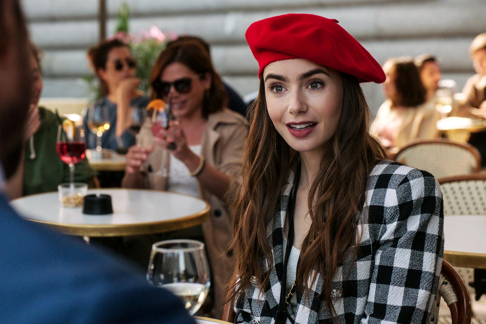 Lily Collins in a still from Emily in Paris wearing a red beret.