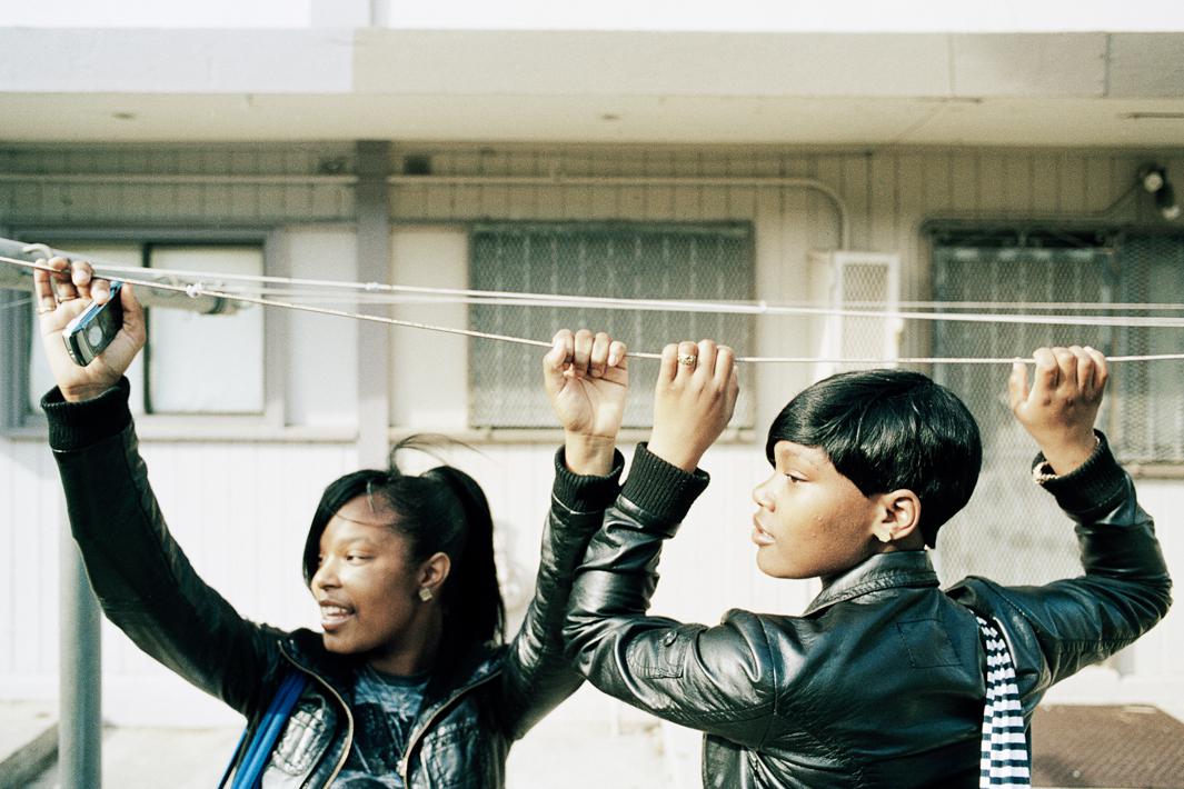 'Ra Ra," left, and 'Mo Drama,' right, hang from the laundry lines in the Hunters View housing projects while waiting for a friend to catch up with them.