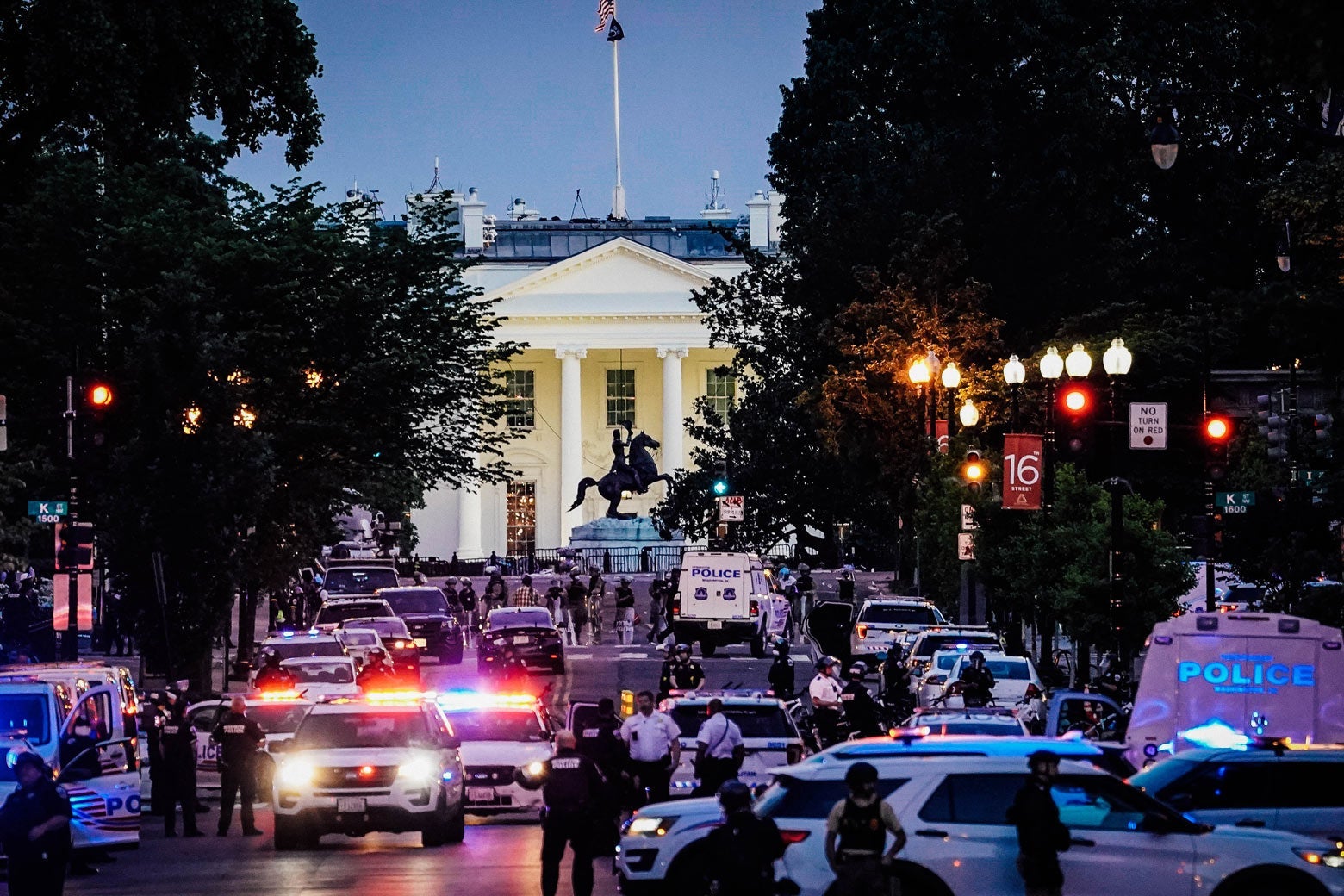 Many police officers and vehicles in front of the White House