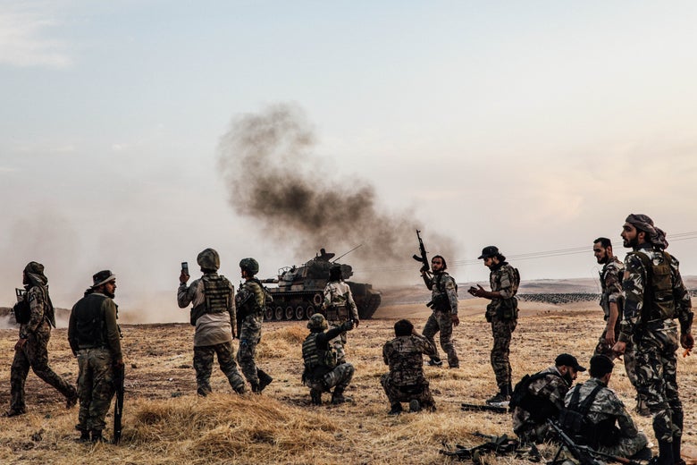 Turkish soldiers and Turkey-backed Syrian fighters gather.