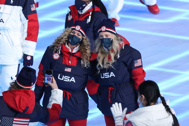 Two U.S. athletes with long blonde hair pose for a photo.