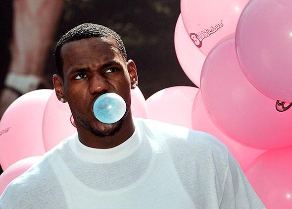 Cleveland Cavalier star LeBron James poses for photos during a Bubblicious bubble- blowing contest.