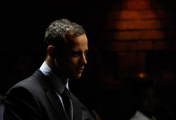 Oscar Pistorius stands in the dock ahead of court proceedings at the Pretoria magistrates court.