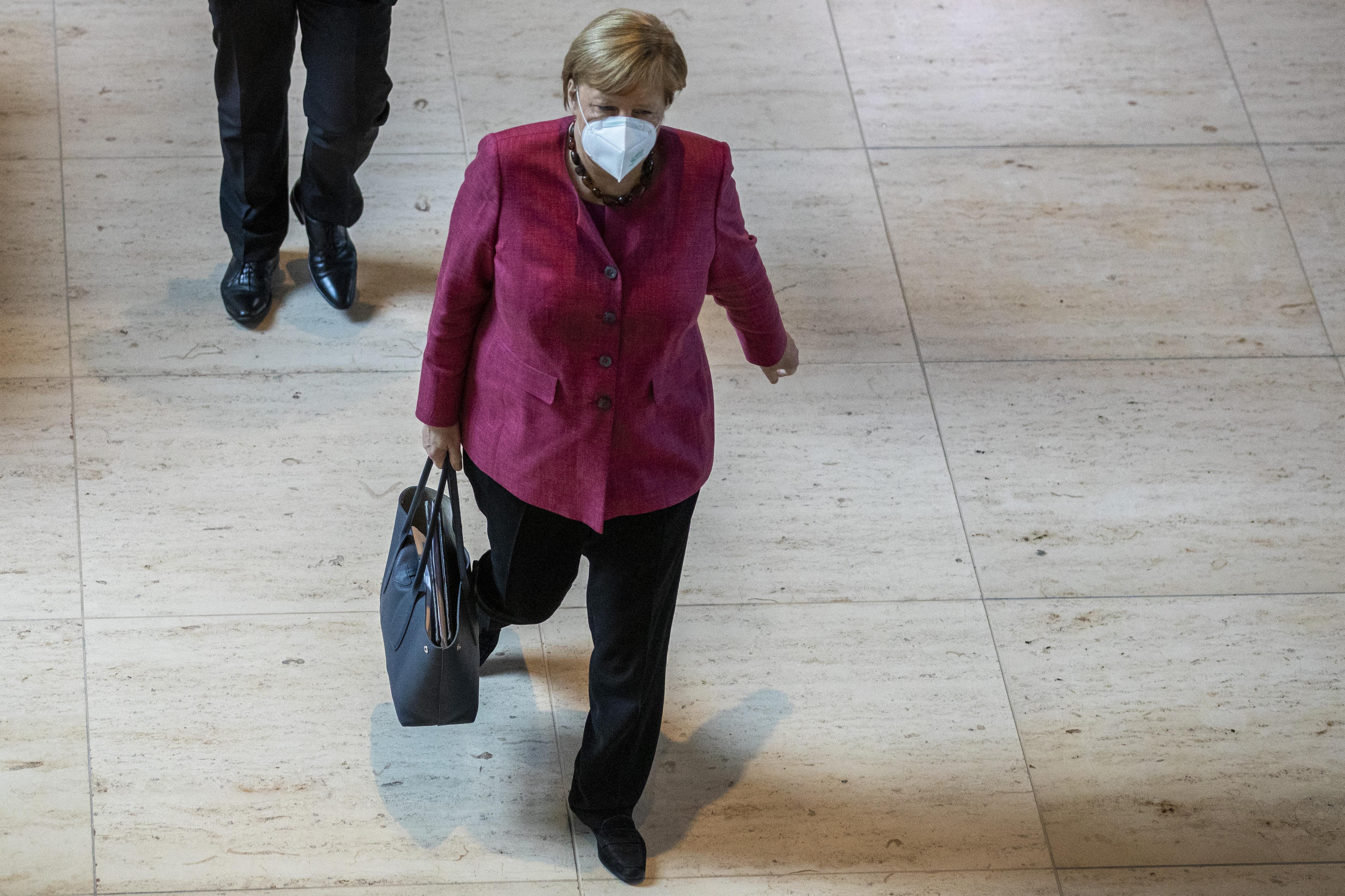 German Chancellor Angela Merkel walks at the Bundestag in Berlin on Thursday