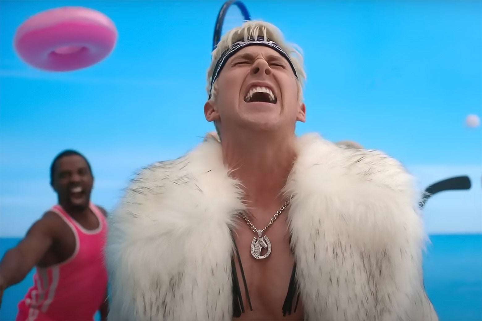 Ryan Gosling wearing a fur vest and a headband while singing with feeling in the Barbie movie.