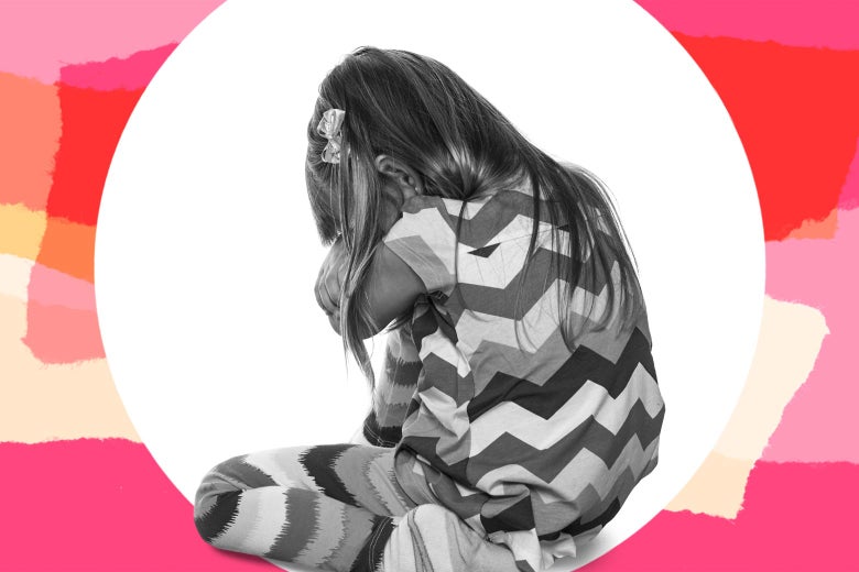 Young girl curled up, looking sad