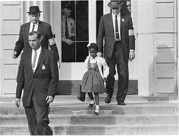 After a federal court ordered the desegregation of schools in the South, U.S. Marshals escorted a young black girl, Ruby Bridges, to school on November 14, 1960, in the midst of racial tension and violence. Bridges attended William Frantz Elementary School in New Orleans and with U.S. Marshals by her side; she became the first black child to enter an all-white school in the history of the American South.