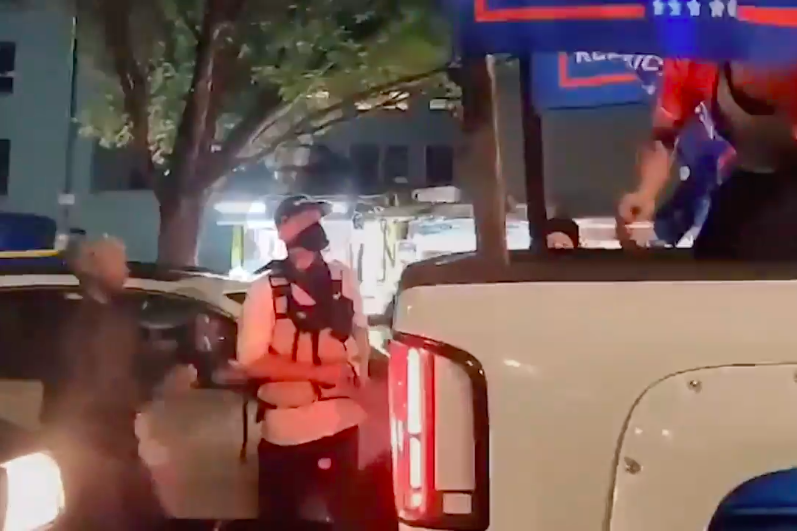 The alleged shooter stands next to a pickup truck at the Portland protest.