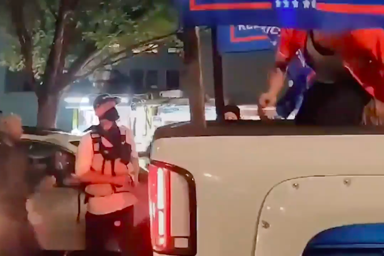 The alleged shooter stands next to a pick up truck at the Portland protest.