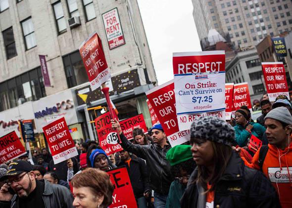 Protesters rally outside of a Wendy's in support of raising fast food wages from $7.25 per hour to $15.00 per hour on December 5, 2013 in the Brooklyn borough of New York City.