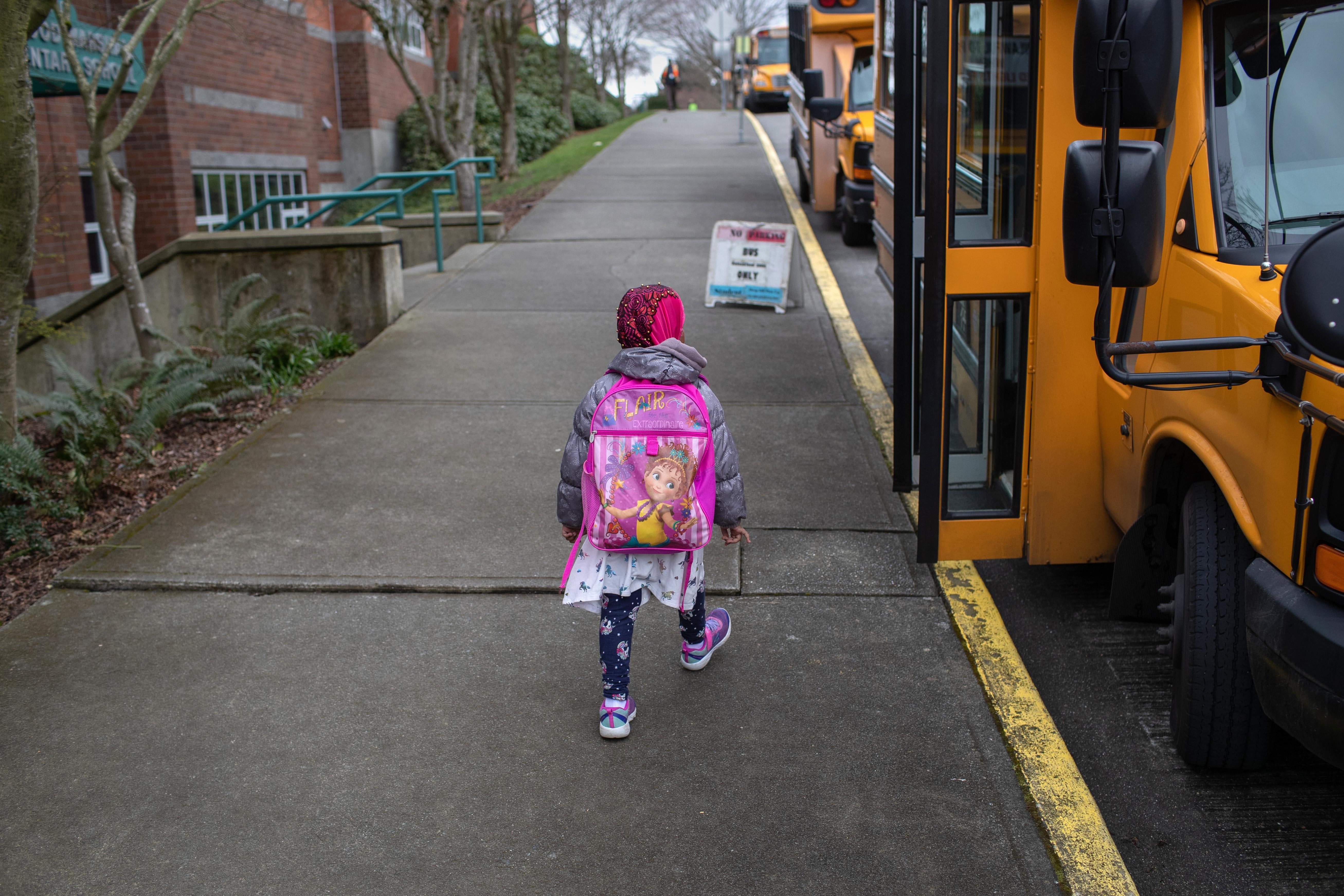 A student leaves the Thurgood Marshal Elementary school after the Seattle Public School system was abruptly closed due to coronavirus fears on March 11, 2020 in Seattle, Washington.