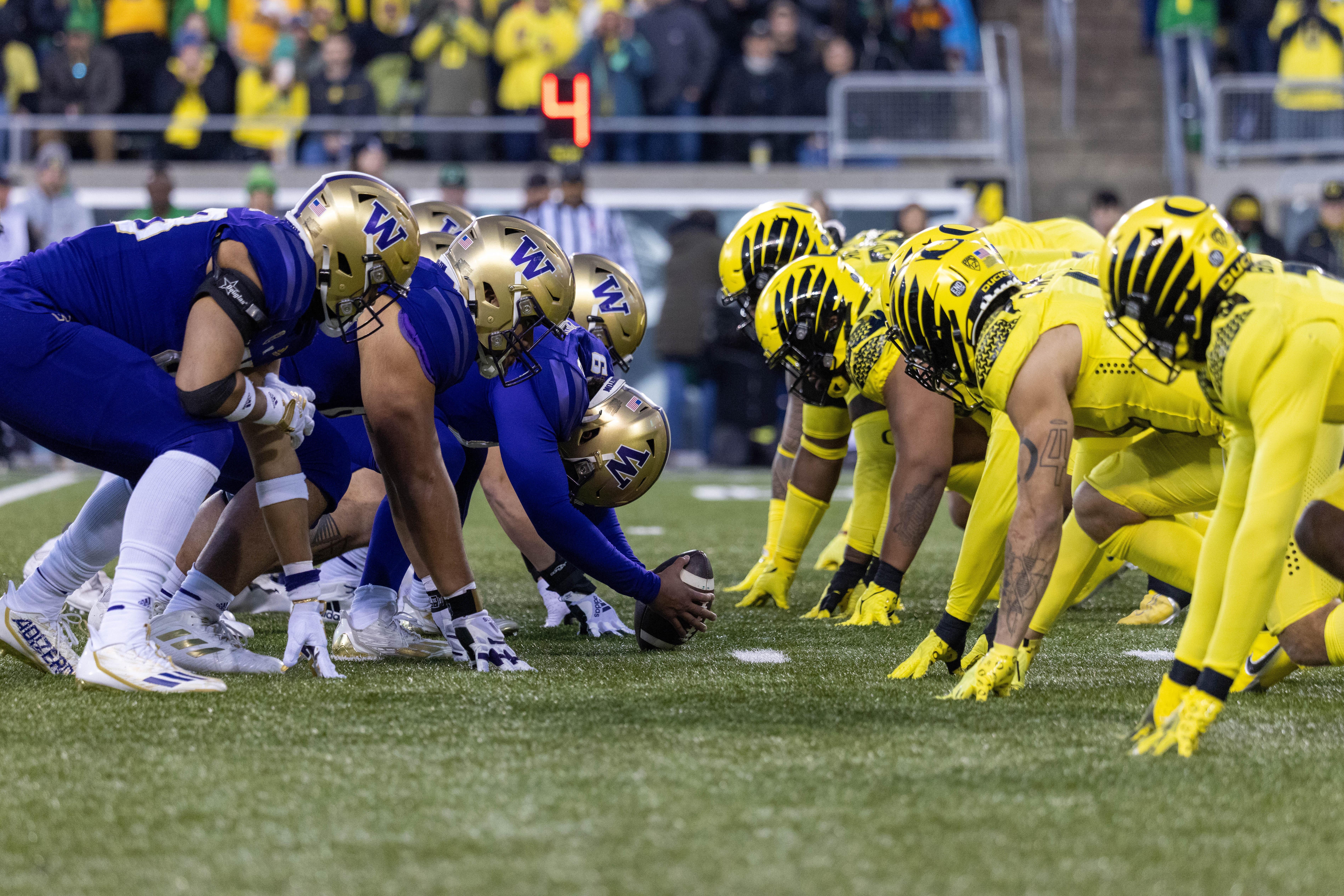 The line of scrimmage between the teams, Washington's center getting ready to snap the ball. 