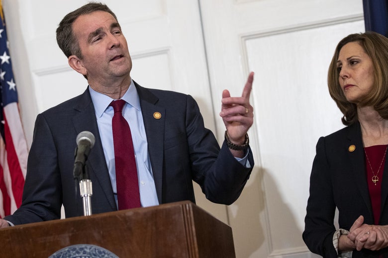 Virginia Governor Ralph Northam, flanked by his wife Pam, speaks with reporters at a press conference at the Governor's mansion on February 2, 2019 in Richmond, Virginia. 