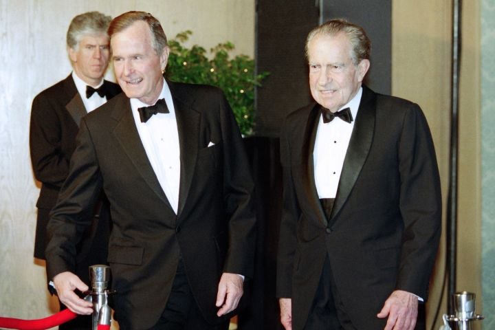 Bush and Nixon smiling while wearing tuxedoes.