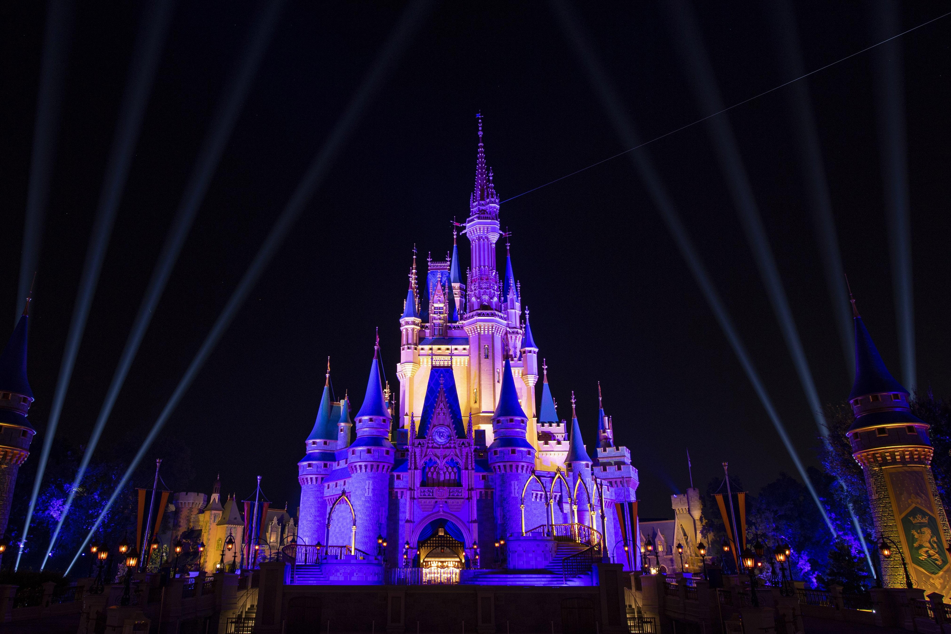 Cinderella's castle inside Disney World, lit purple.