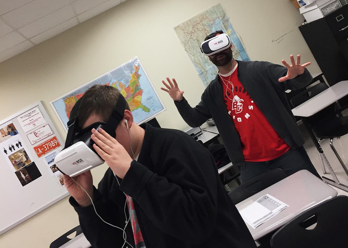 Boyd County High School teacher William Parker and a 10th grade student immerse themselves in “One World, Many Stories: Amman Jordan.” The virtual reality technology makes them feel they are underneath an ancient ruin at the Citadel in Amman. 