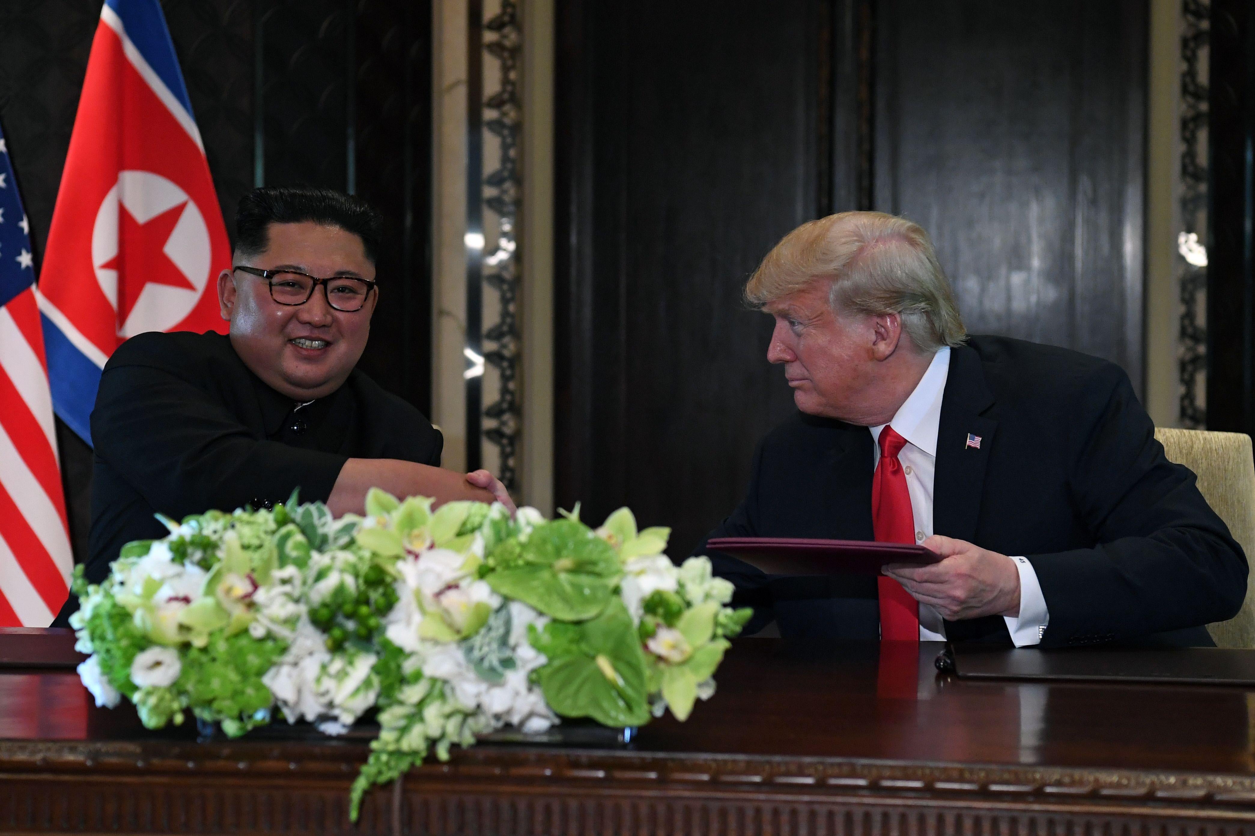 Kim Jong-un shakes hands with Donald Trump