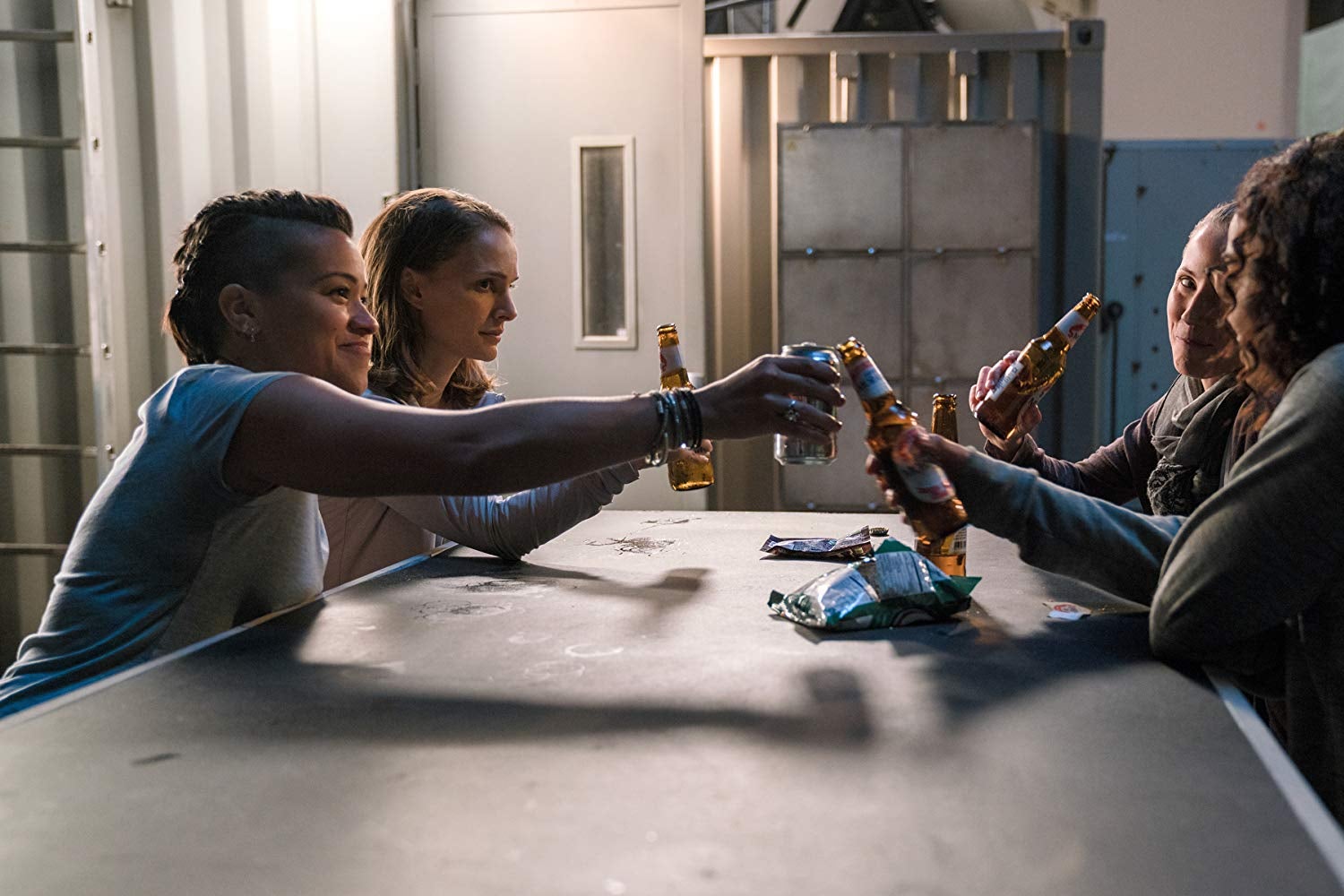 Natalie Portman, Tuva Novotny, Gina Rodriguez, and Tessa Thompson clink beer bottles.