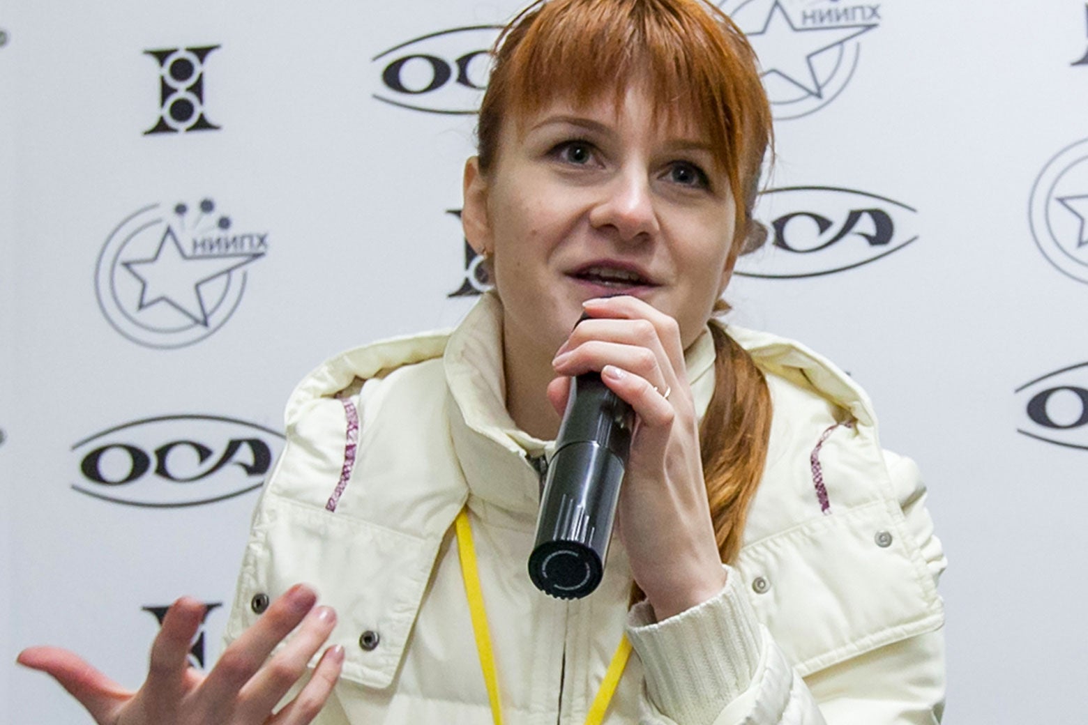 Mariia Butina speaks into a microphone at a press conference.