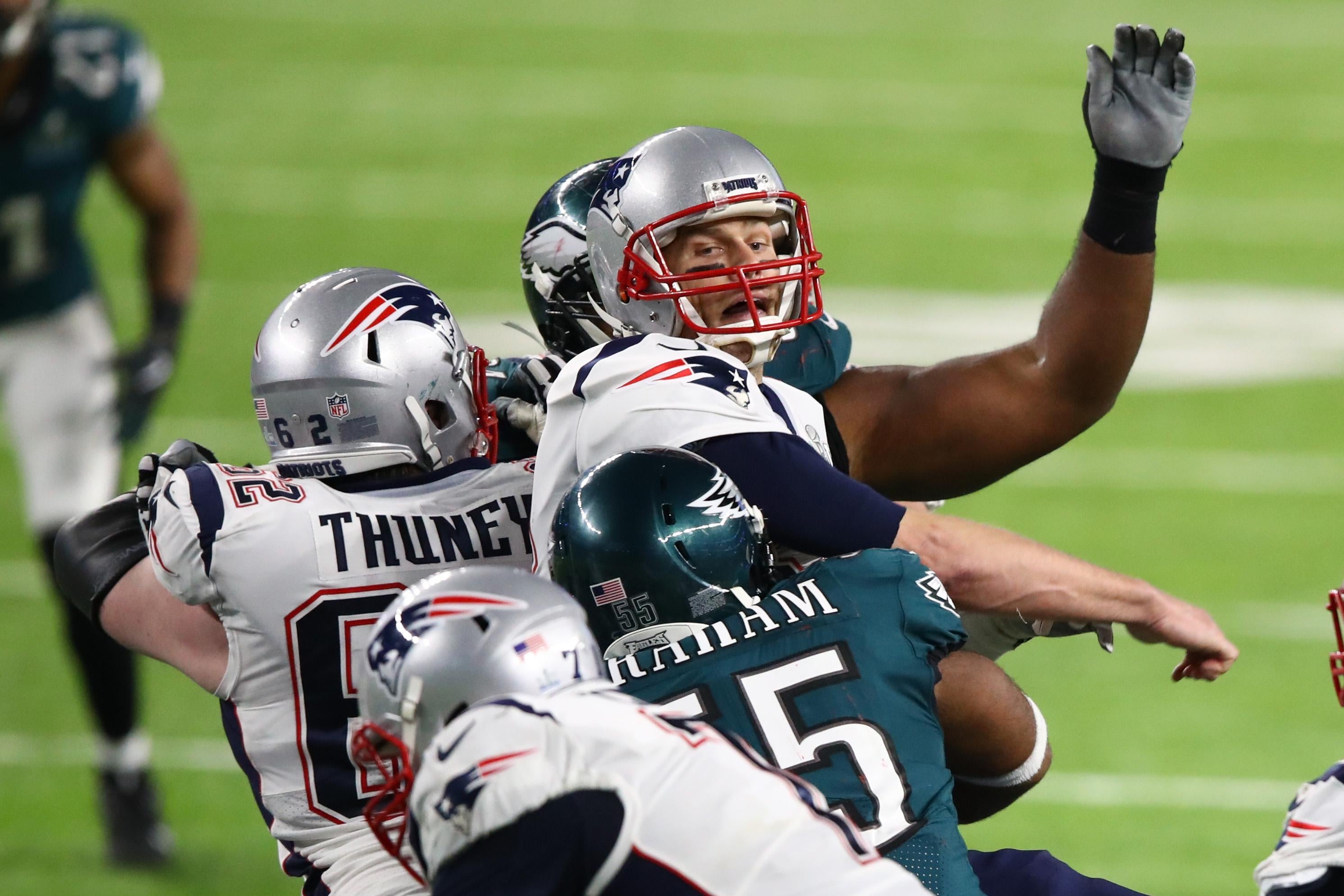 New England Patriots quarterback Tom Brady sits dejectedly near the Super  Bowl logo after losing a fumble late in the fourth quarter against the Philadelphia  Eagles in Super Bowl LII at U.S.