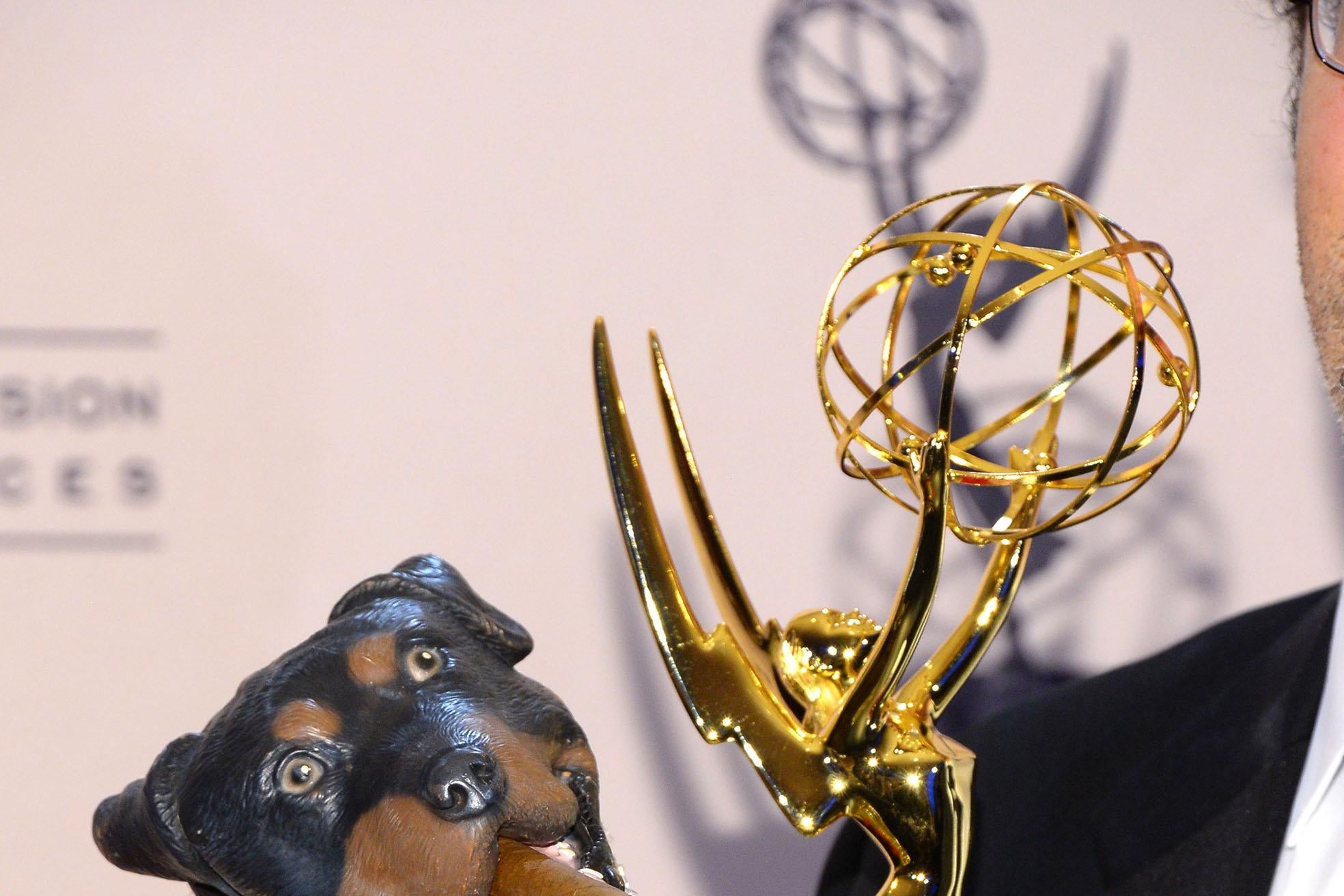 Triumph the Insult Comic Dog, a rubber dog puppet, holding an Emmy.