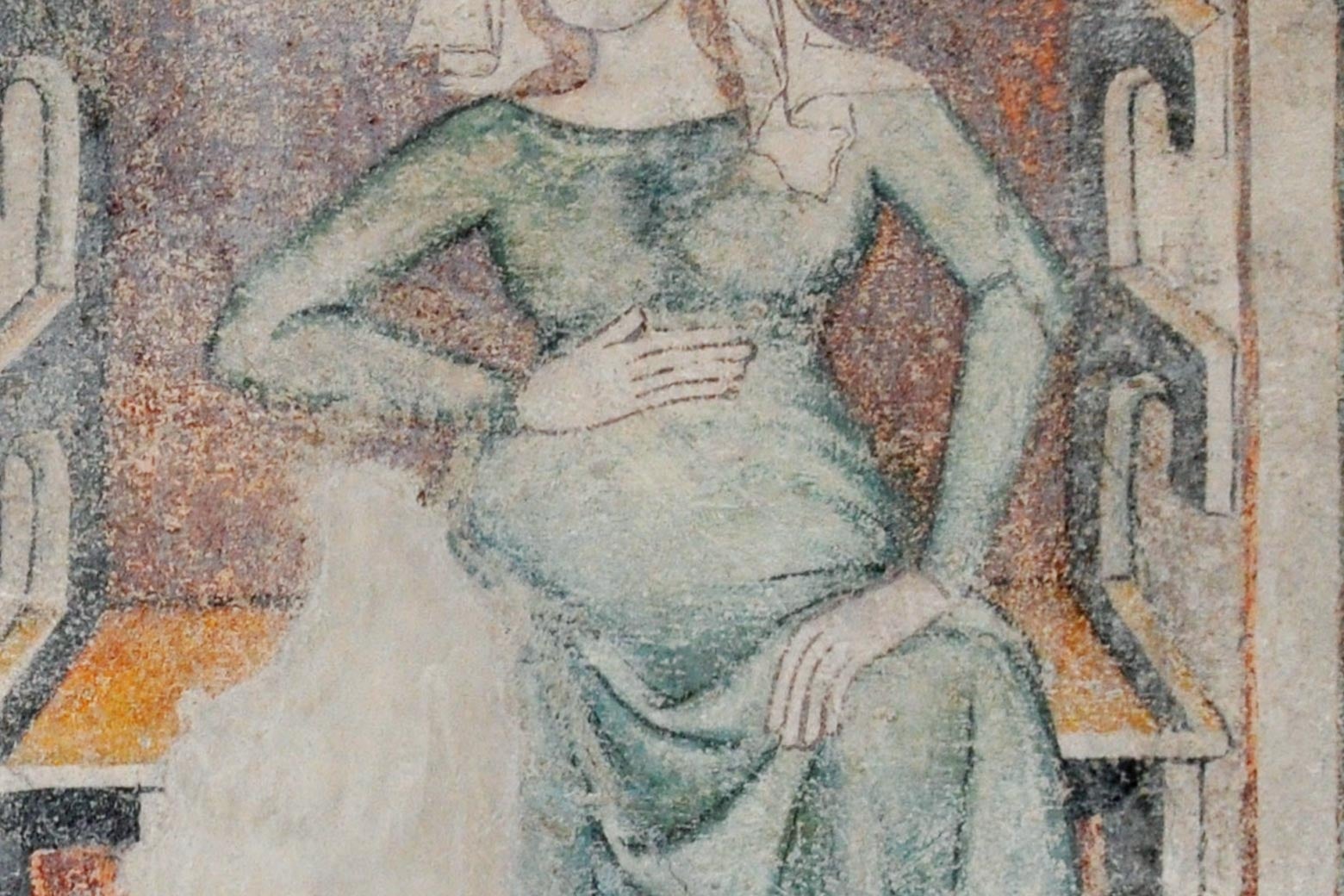 Detail of medieval fresco depicting a pregnant woman with one hand on her belly. 