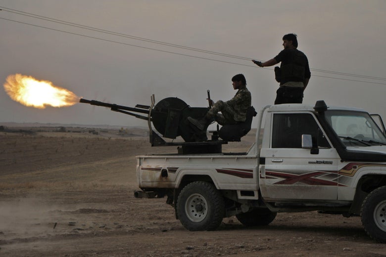 Turkish-backed Syrian fighters fire a truck mounted heavy gun near the town of Tukhar, north of Syria's northern city of Manbij, on October 14, 2019, as Turkey and it's allies continues their assault on Kurdish-held border towns in northeastern Syria.