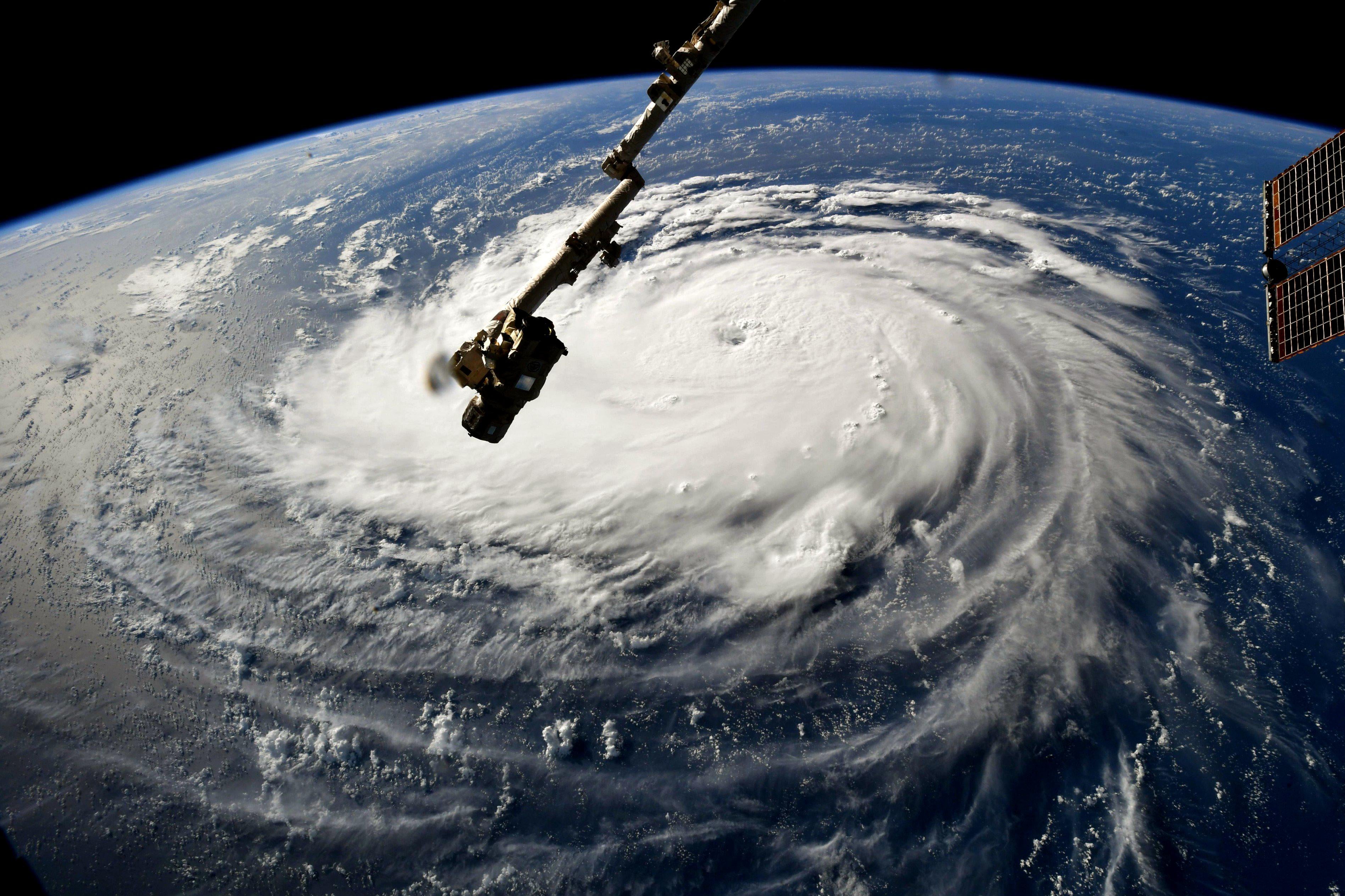 A satellite image of Hurricane Florence, with a part of the International Space Station visible in the foreground.