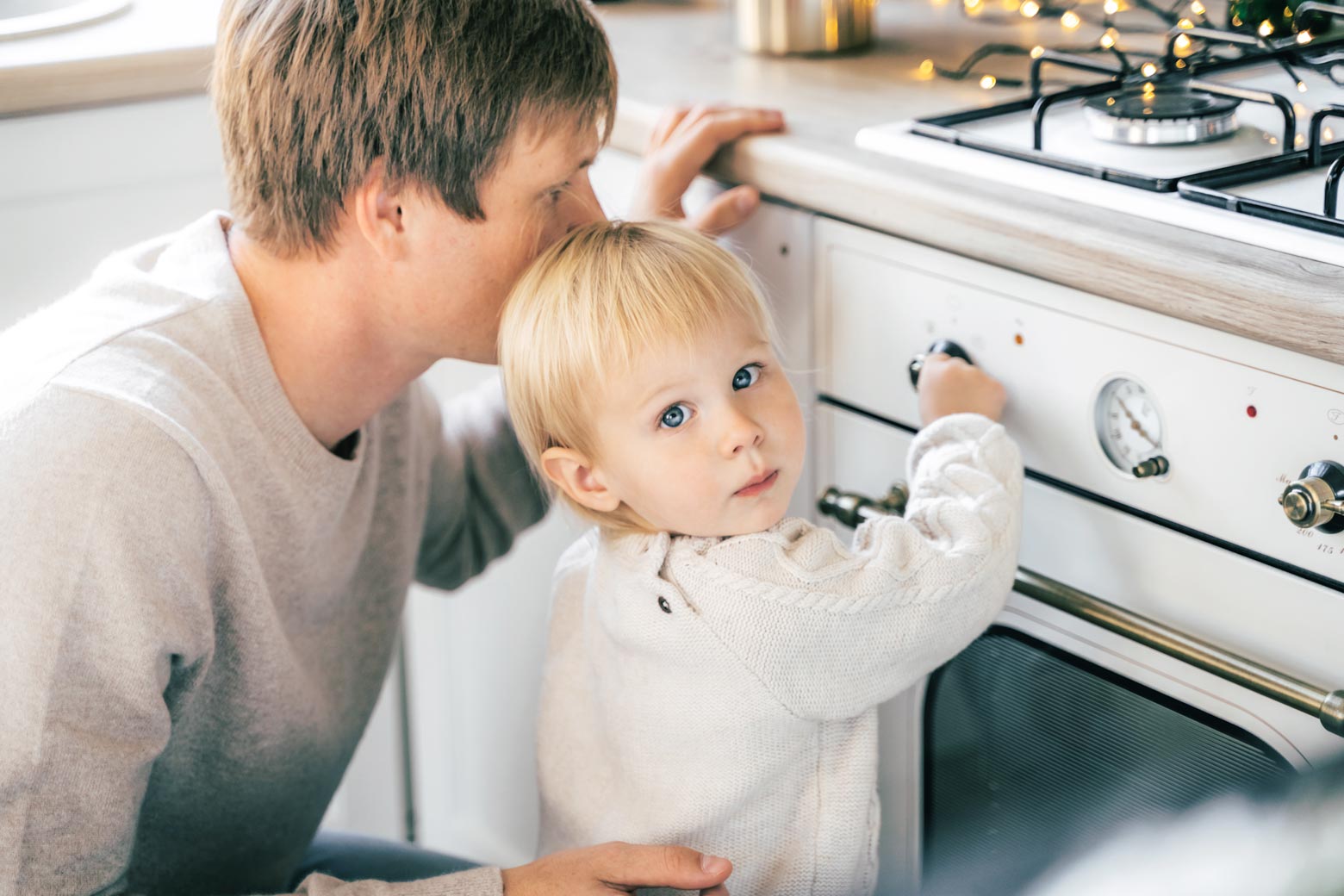 Child and father next to a gas stove.