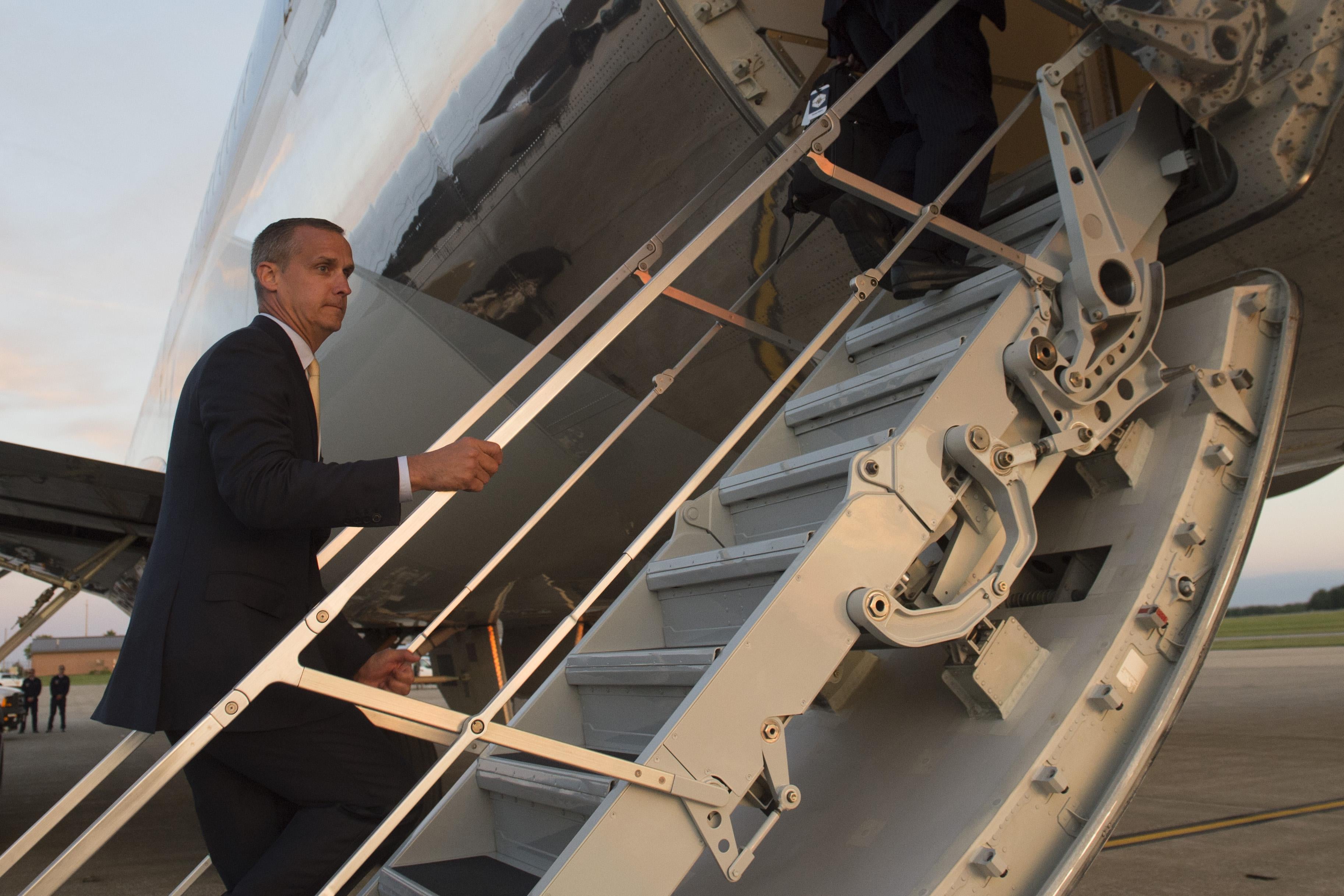 Former campaign aide Corey Lewandowski boards Air Force One prior to departure from Youngstown-Warren Regional Airport in Vienna, Ohio, July 25, 2017, following a campaign rally with US President Donald Trump. / AFP PHOTO / SAUL LOEB        (Photo credit should read SAUL LOEB/AFP/Getty Images)