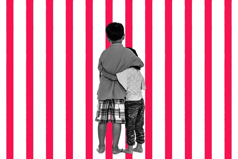 Two young boys hold each other against a striped background.