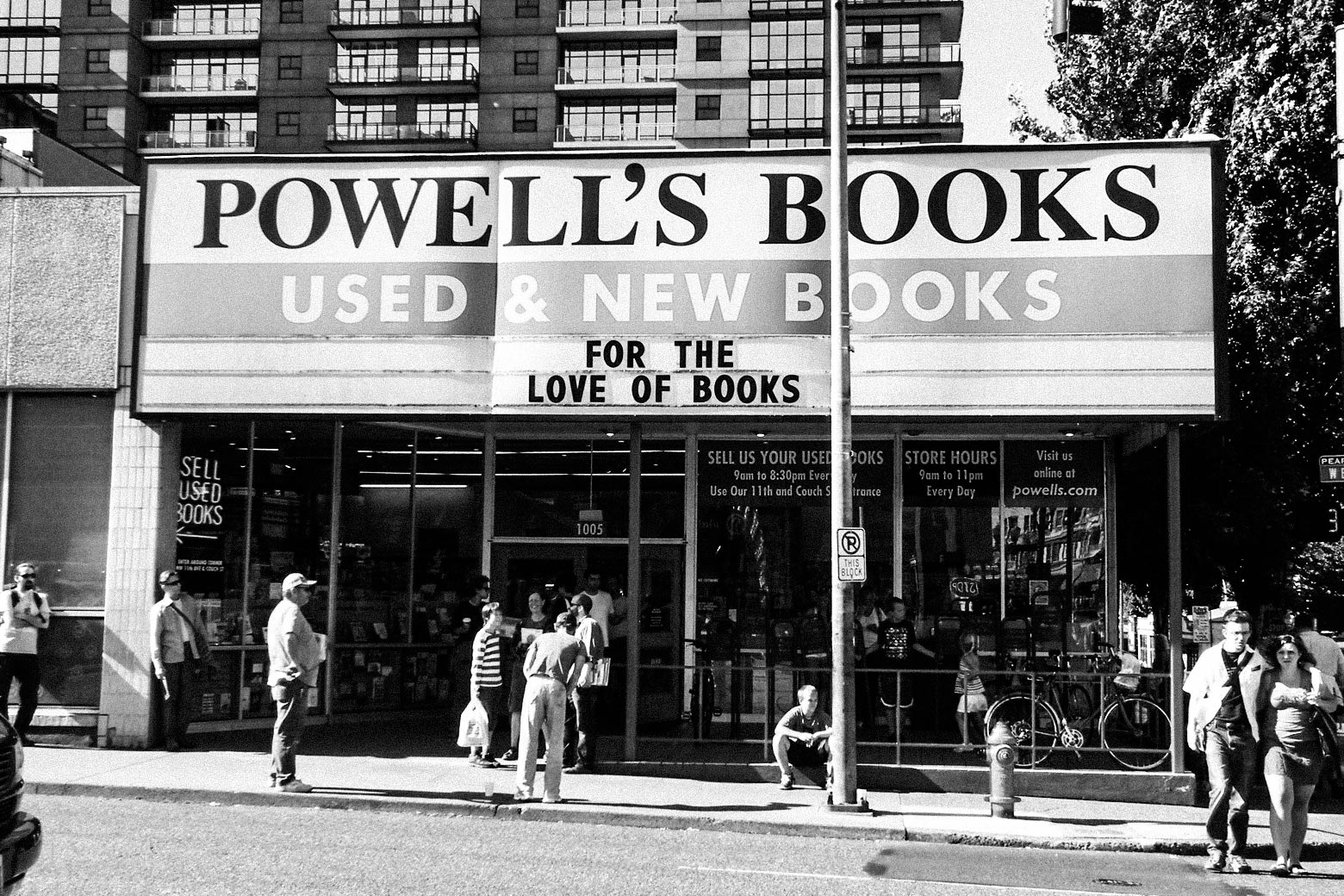 The facade of Powell’s Books with people milling outside.