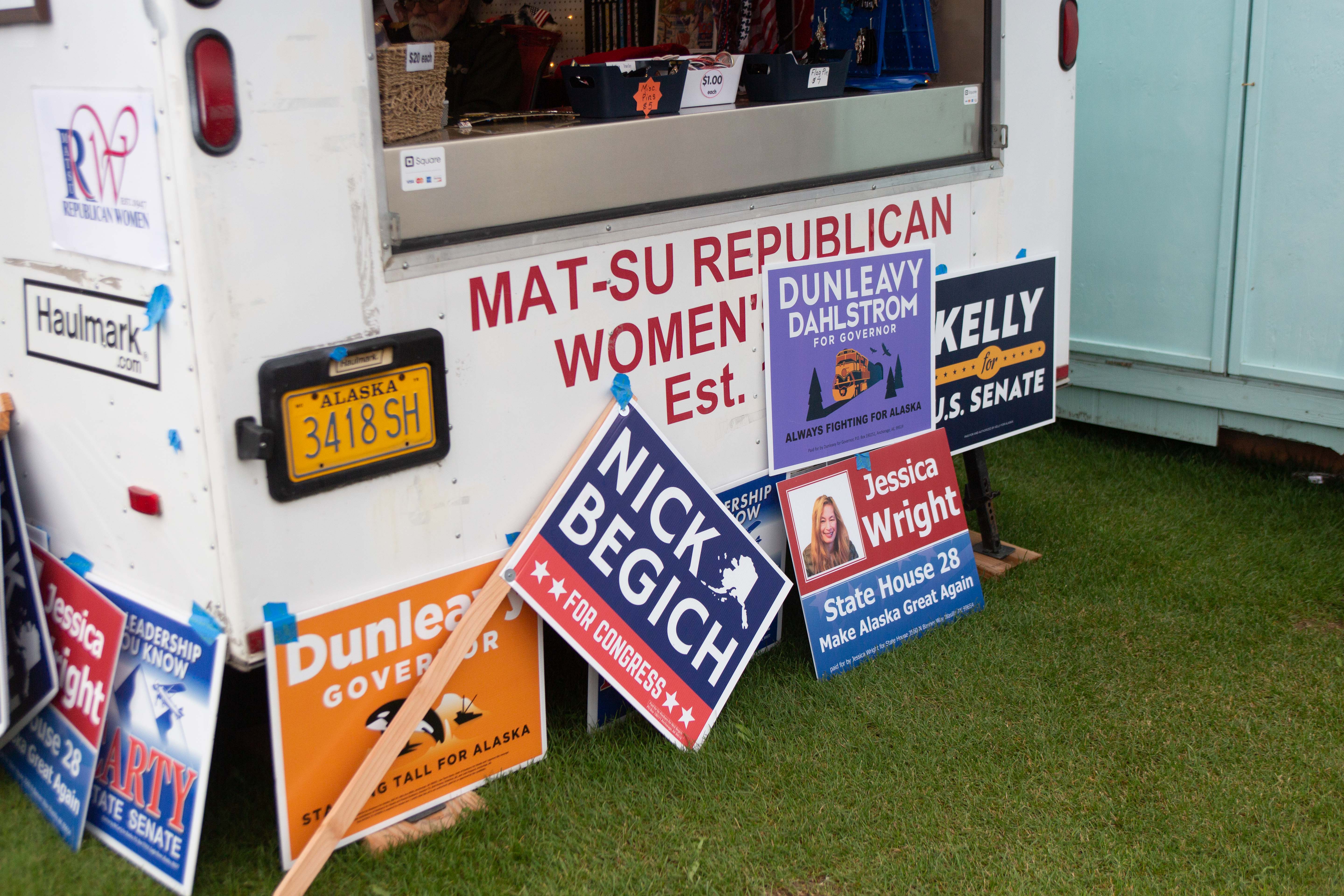 A parked truck with various candidate signs